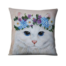 a white cat sitting on top of a couch 