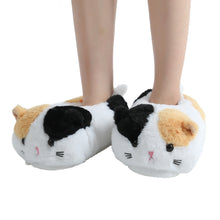 Black and white spotted cat slippers.